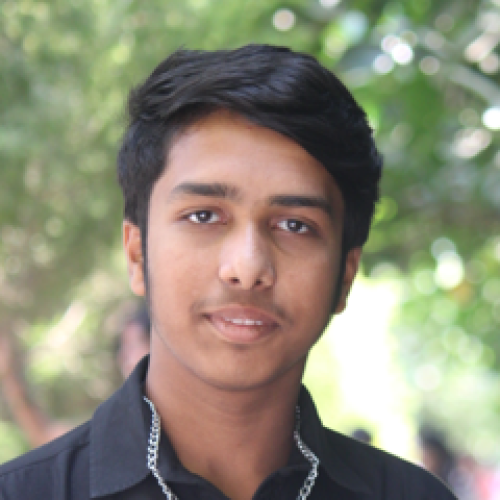 Photo of young man in black button-up shirt. 