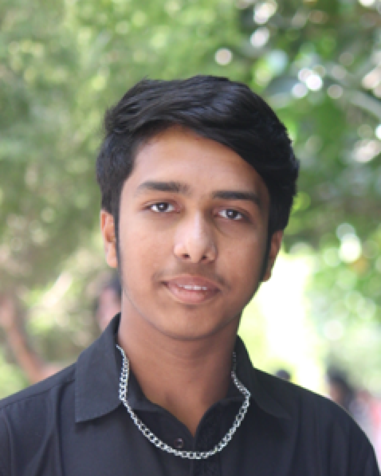 Photo of young man in black button-up shirt. 